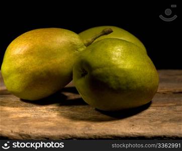 autumn fresh pears over old wood board