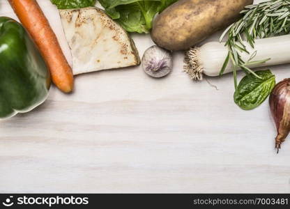 autumn fresh vegetables and fresh herbs on white rustic wooden background top view boarder