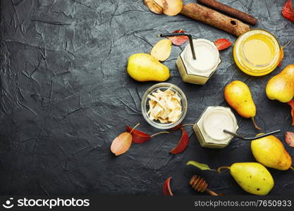 Autumn fruit drink.Pear and ginger smoothie and fallen leaves.Copy space. Ginger smoothie with pear.