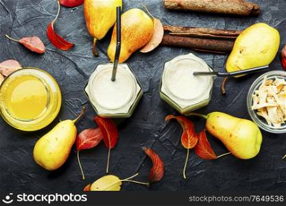 Autumn fruit drink.Pear and ginger smoothie and fallen leaves. Ginger smoothie with pear.
