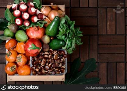 Autumn fruitage. Wooden box with seasonal fruits and vegetables, harvesting, food delivery to the consumer. Top view with copy space