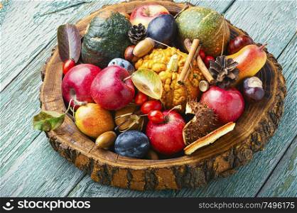 Autumn fruits and pumpkins with fallen leaves.Autumn harvest on wooden table. Beautiful autumn composition