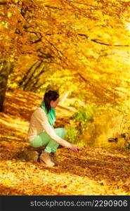 Autumn fruits, nature concept. Woman relaxing in park or autumnal forest holding apple.. Woman relaxing in park holding apple fruit