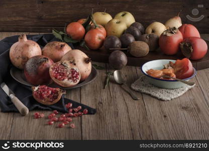 Autumn fruits on rustic table in vintage style.