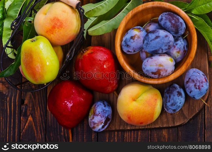 autumn fruits on the wooden table, harvest on a table