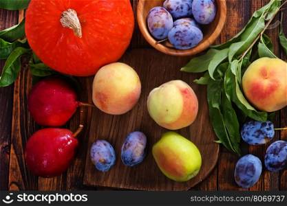 autumn fruits on the wooden table, harvest on a table