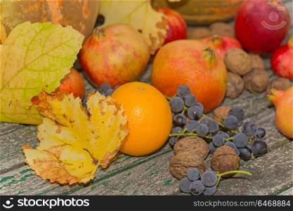 autumn fruits set on a wooden table, outdoor