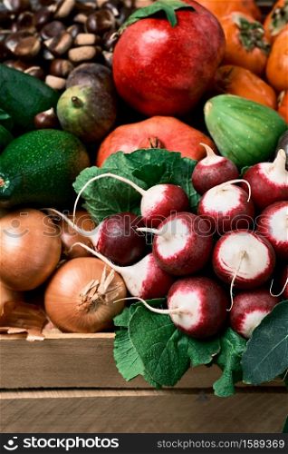 Autumn fruits. Wooden box with seasonal fruits and vegetables, harvesting, food delivery to the consumer. Close-up, selective focus
