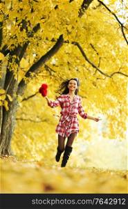 autumn happy woman portrait run in park. autumn woman run