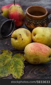 Autumn harvest of pears. Ripe autumn pear varieties on vintage background of wood