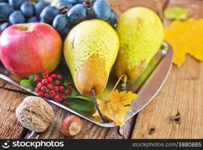 autumn harvest on the wooden background, fruits and vegetables