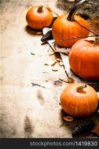 Autumn harvest. Ripe pumpkin with leaves. On wooden background.. Autumn harvest. Ripe pumpkin with leaves.