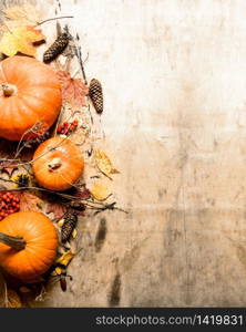 Autumn harvest. Ripe pumpkin with leaves. On wooden background.. Autumn harvest. Ripe pumpkin with leaves.