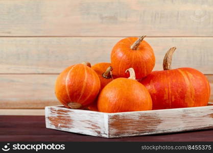 Autumn harvest. Ripe pumpkins in a wooden box. Thanksgiving and halloween concept. Eco-friendly farm products. Copy space.. Autumn harvest. Ripe pumpkins in wooden box. Thanksgiving and halloween concept. Eco-friendly farm products. 