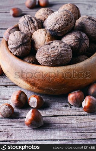 Autumn harvest walnuts and hazelnuts on wooden background. walnuts with hazelnuts