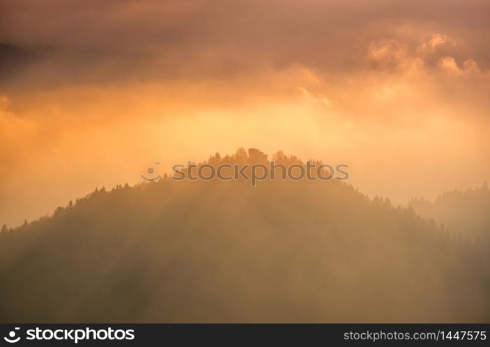 Autumn hazy day Berchtesgadener Land and mount Watzmann silhouette fragments in contra light cloudy view from Marxenhohe viewpoint, Bavarian prealps, Germany