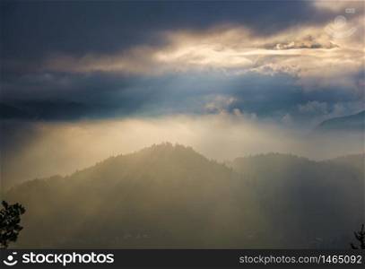 Autumn hazy day Berchtesgadener Land and mount Watzmann silhouette fragments in contra light cloudy view from Marxenhohe viewpoint, Bavarian prealps, Germany