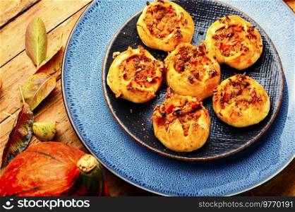 Autumn homemade pastries.Fresh buns with minced meat and pumpkin.. Pumpkin and meat buns
