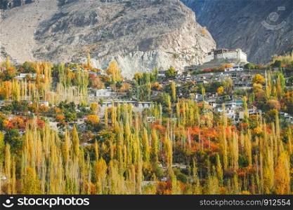 Autumn in Hunza valley with a view of Baltit fort and villages surround by mountains and forest trees. Karimabad, Gilgit Baltistan, Pakistan.