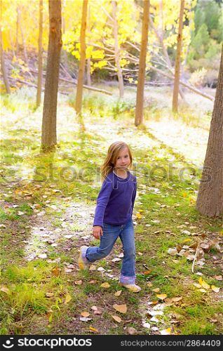Autumn kid girl running poplar tree forest motion blur in nature outdoor
