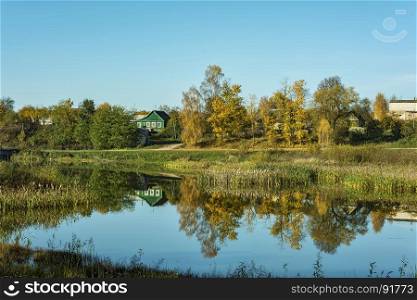 Autumn landscape. Countryside and the reflection of nature in the pond