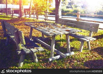Autumn landscape - in the park a bench and a table in the leaves