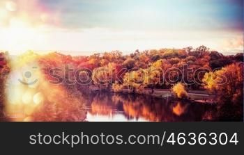 Autumn landscape of City Park with colorful trees and lake at sunset light with bokeh, panoramic banner