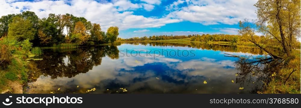 Autumn Landscape. Park in Autumn. The bright colors of autumn in the park by the lake. Panorama