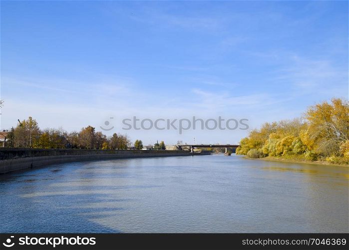 Autumn landscape. River bank with autumn trees. Poplars on the banks.. Autumn landscape. River bank with autumn trees. Poplars on the b
