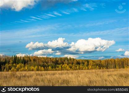 Autumn landscape with beautiful clouds on a blue background in an October day.