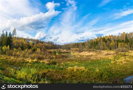 Autumn landscape with beautiful clouds on a blue background in an October day.