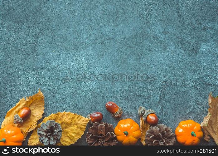 Autumn Leaves, decorative pumkins, acorns and cones over blue wooden background. Copyspace. Autumn Leaves, decorative pumkins, acorns and cones over blue wooden background