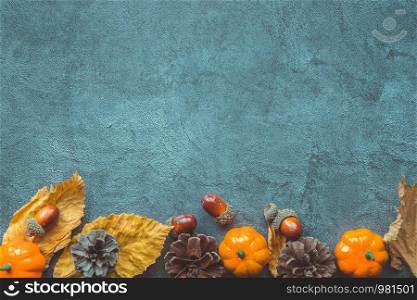 Autumn Leaves, decorative pumkins, acorns and cones over blue wooden background. Copyspace. Autumn Leaves, decorative pumkins, acorns and cones over blue wooden background