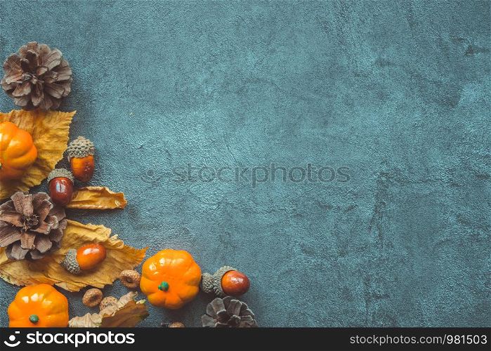 Autumn Leaves, decorative pumkins, acorns and cones over gray. Copyspace. Autumn Leaves, decorative pumkins, acorns and cones over gray background