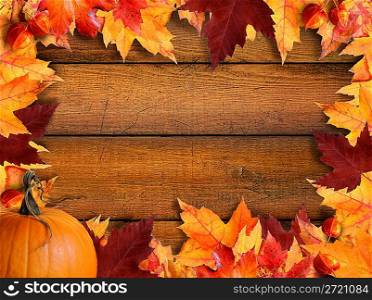 Autumn leaves frame on wood