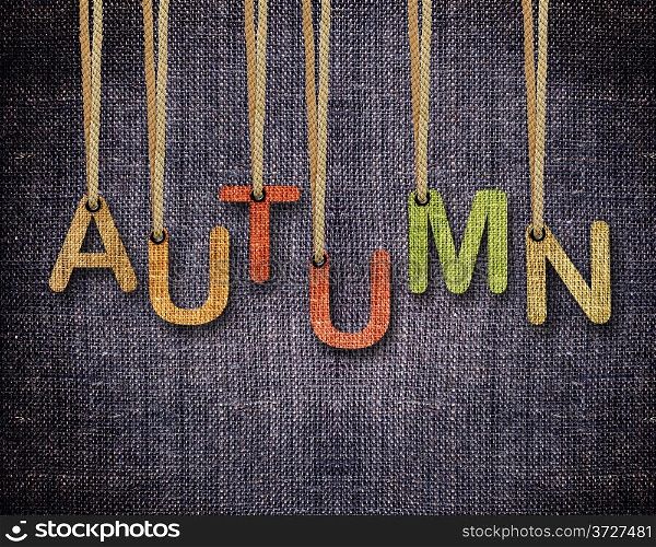 Autumn letters hanging strings with blue sackcloth background.. Autumn