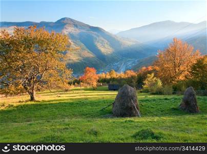 Autumn misty evening mountain hill with stack of hay (Rahiv town outskirts, Carpathian Mt&rsquo;s, Ukraine).