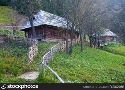 Autumn misty mountain village with wooden house (Carpathian , Ukraine).