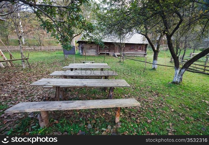 Autumn misty mountain village with wooden schoolhouse(Carpathian , Ukraine).