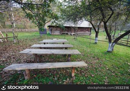 Autumn misty mountain village with wooden schoolhouse(Carpathian , Ukraine).