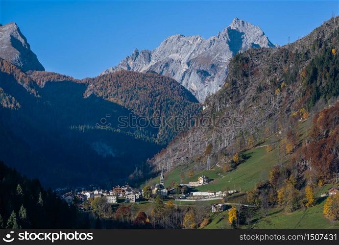 Autumn morning alpine Dolomites mountain scene, Belluno, Sudtirol, Italy. Picturesque view from Sac village, in direction of Rocca Pietore village and Marmolada mountains (Gruppo della Marmolada).