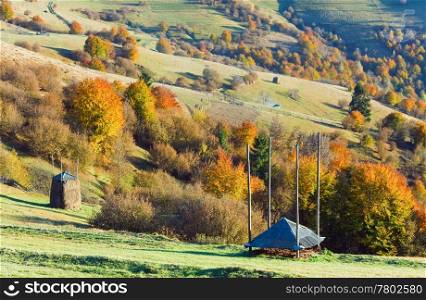 Autumn mountain country landscape with haystack on slope (Carpathian, Ukraine).