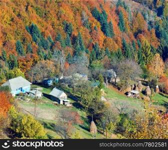 Autumn mountain Nimchich pass (Carpathian, Ukraine), colorful forest and country estate on hill.