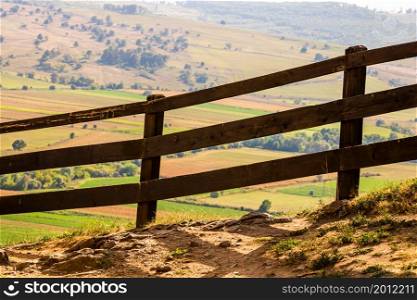 Autumn mountains panorama with the old wooden fence