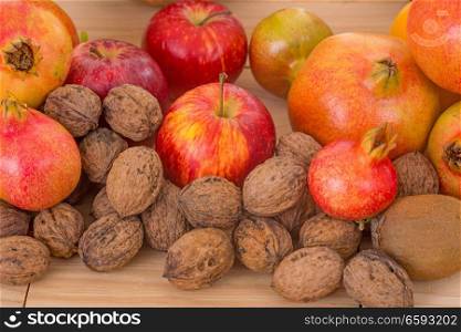 Autumn nature fruits concept. Fall fruits on a wooden table, studio picture