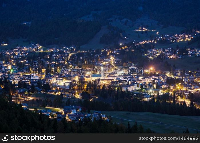 Autumn night Cortina d&rsquo;Ampezzo alpine Dolomites mountain town, Belluno, Italy. Picturesque traveling and countryside beauty concept scene.