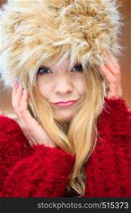 Autumn or winter fashion. Closeup happy young woman wearing fashionable wintertime clothes fur cap outdoor portrait