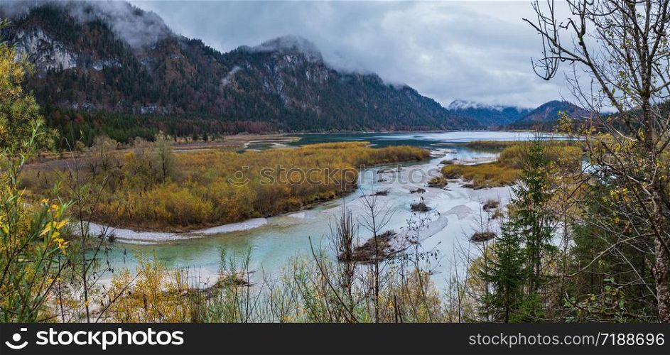 Autumn overcast Sylvenstein Lake and bridge on Isar river, Karwendel Bavarian Prealps, Germany. Picturesque traveling, seasonal and nature beauty concept scene.