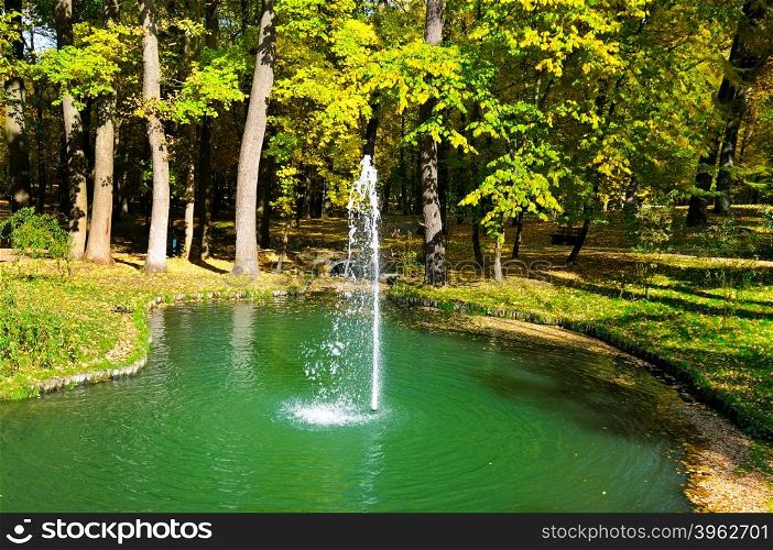 autumn park, a pond and a small fountain
