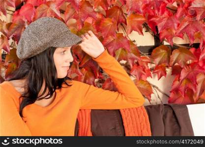 Autumn park scenery young woman relax on bench looking aside